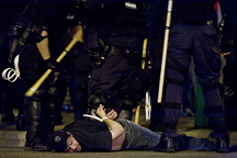 man on ground handcuffed by police
