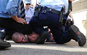 police handcuffting a man on the ground