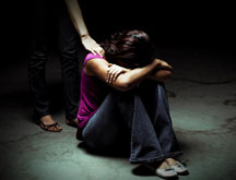 Woman holding head on knees ashamed